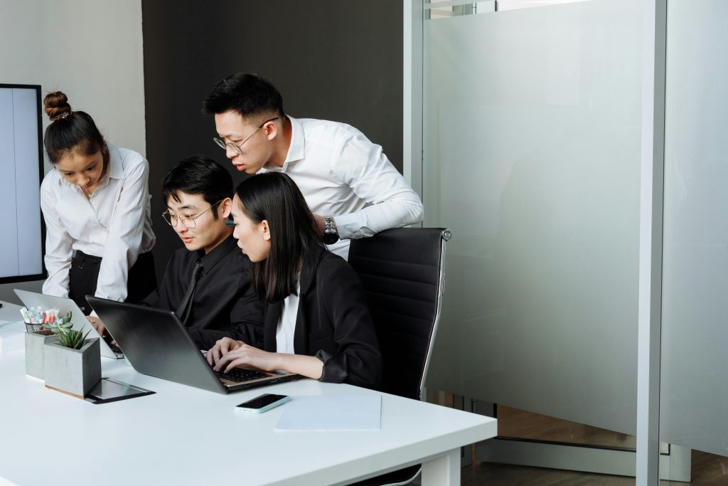 Team of professionals engaged in a collaborative business meeting in a modern office setting.